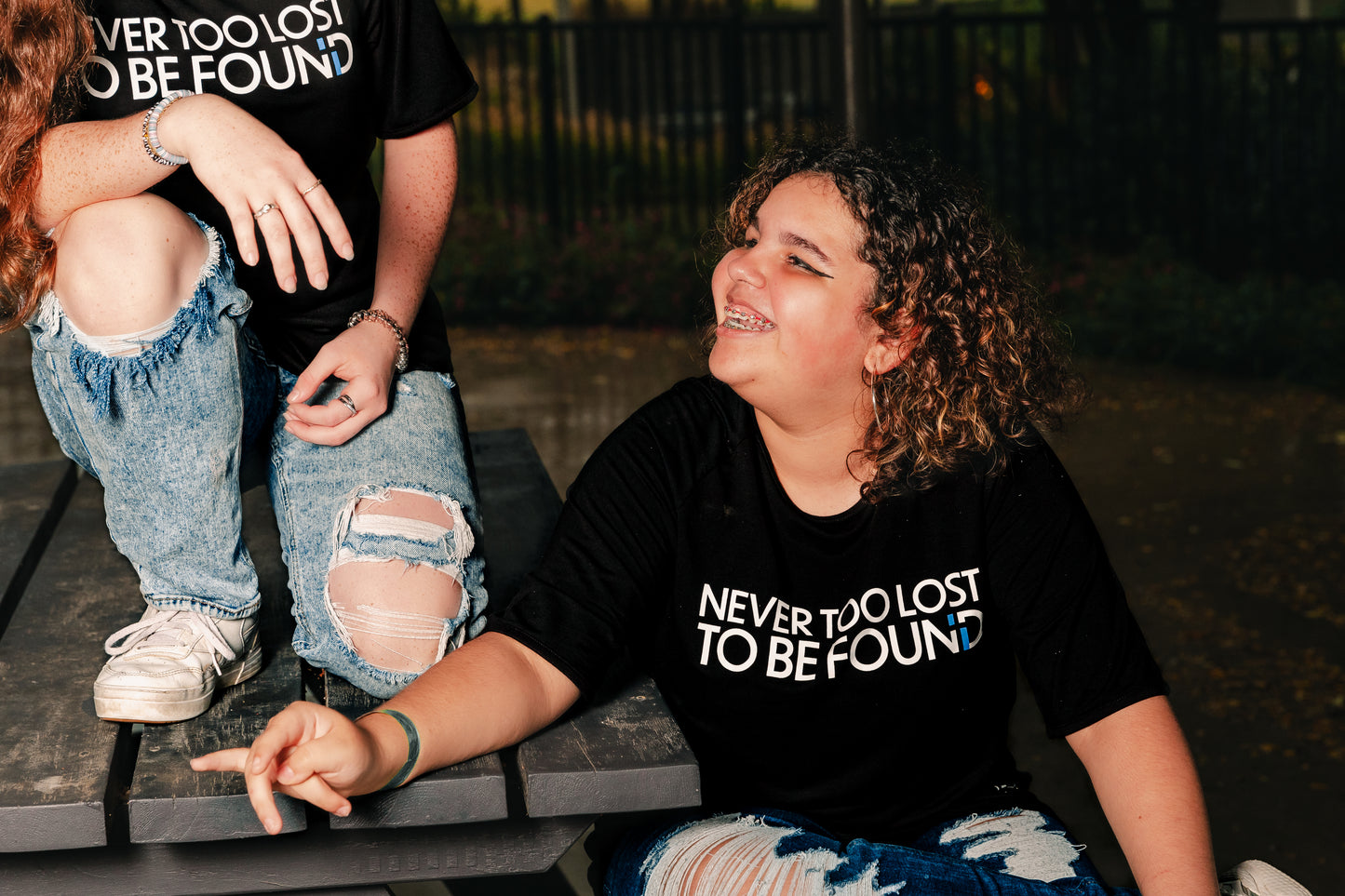 Young women wearing Now Found Apparel's midnight "Never Too Lost To Be Found" bamboo tees. Comfortable and stylish Christian t-shirts. Shop Now Found Apparel for faith-based apparel.