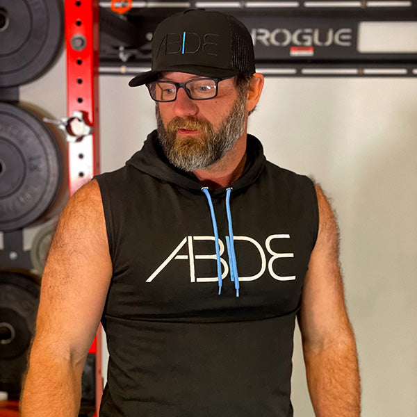 christian man at gym wearing now found apparel midnight black abide sleeveless hoodie