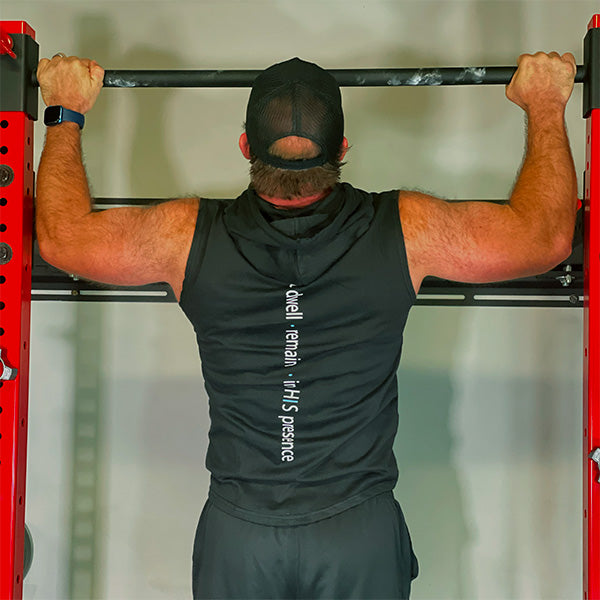 man doing pullups wearing now found christian apparel midnight black abide sleeveless hoodie