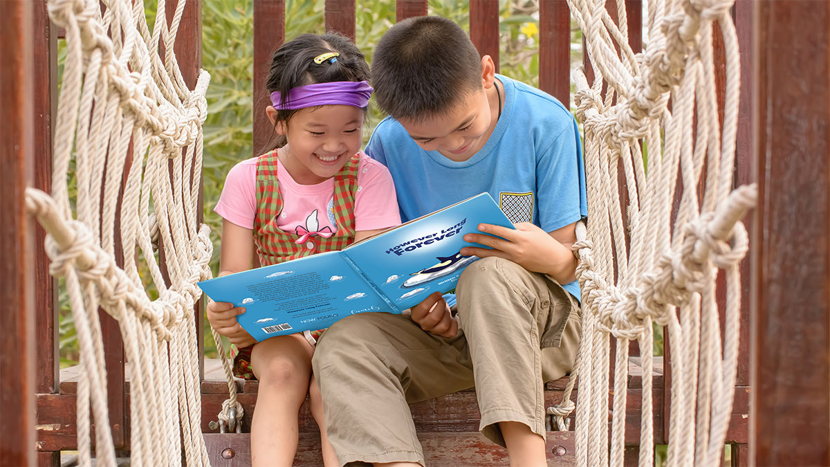 Banner image: Happy siblings are reading "However Long Forever" by Steven Cohen on a playground. They are sitting close together and appear to be engaged in the story