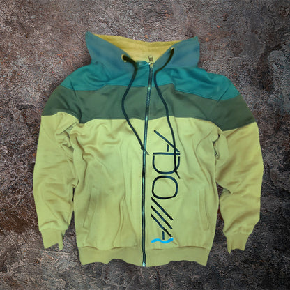 Color-blocked hoodie with ADONAI (Lord) logo on a textured surface