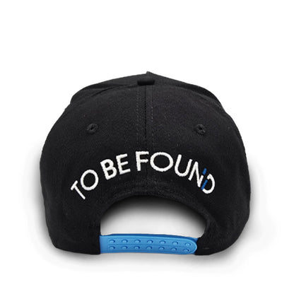 Black Never Too Lost cap back with 'TO BE FOUND' text with bright blue snaps on a white background