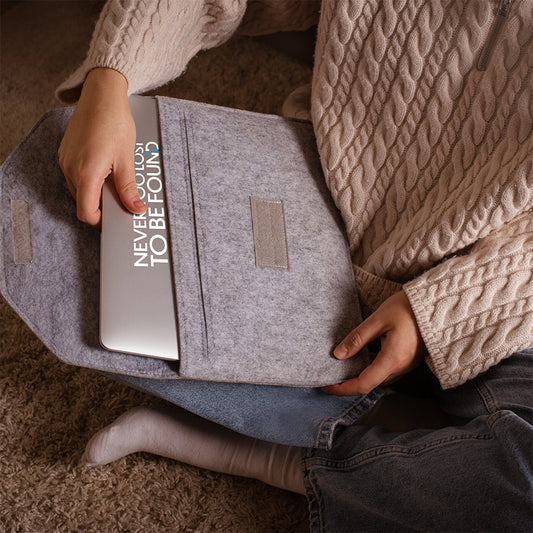 teen girl pulling out macbook with Never Too Lost To Be Found vinyl sticker on it