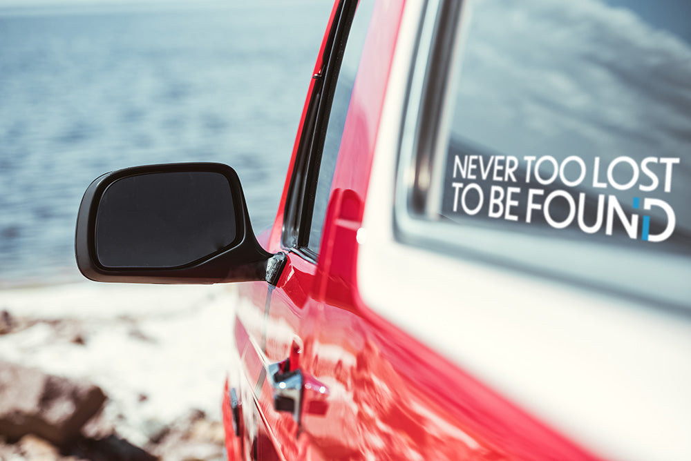 red jeep with Never Too Lost To Be Found sticker in rear window