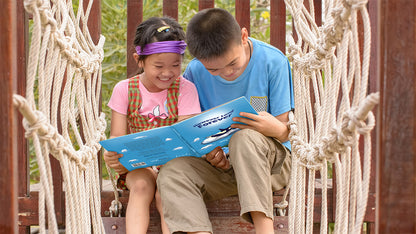 Banner image: Happy siblings are reading "However Long Forever" by Steven Cohen on a playground. They are sitting close together and appear to be engaged in the story